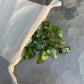 Top view of Grade AA Peridot tumbled stone, carried for Abundance, from San Carlos Apache Reservation, Arizona, United States.