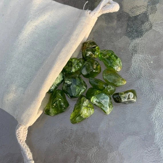 Top view of Grade AA Peridot tumbled stone, carried for Abundance, from San Carlos Apache Reservation, Arizona, United States.