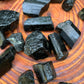 Alternate angle of Grade AA Black Tourmaline raw showing overall shape