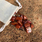 Back view of Grade AA Red Jasper tumbled stone showing natural surface
