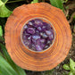 Detail shot of Grade AAA Amethyst tumbled stone under natural light