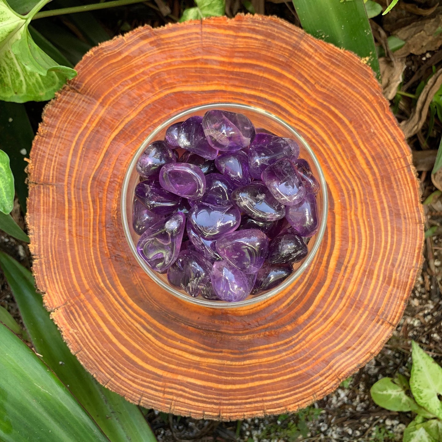 Detail shot of Grade AAA Amethyst tumbled stone under natural light