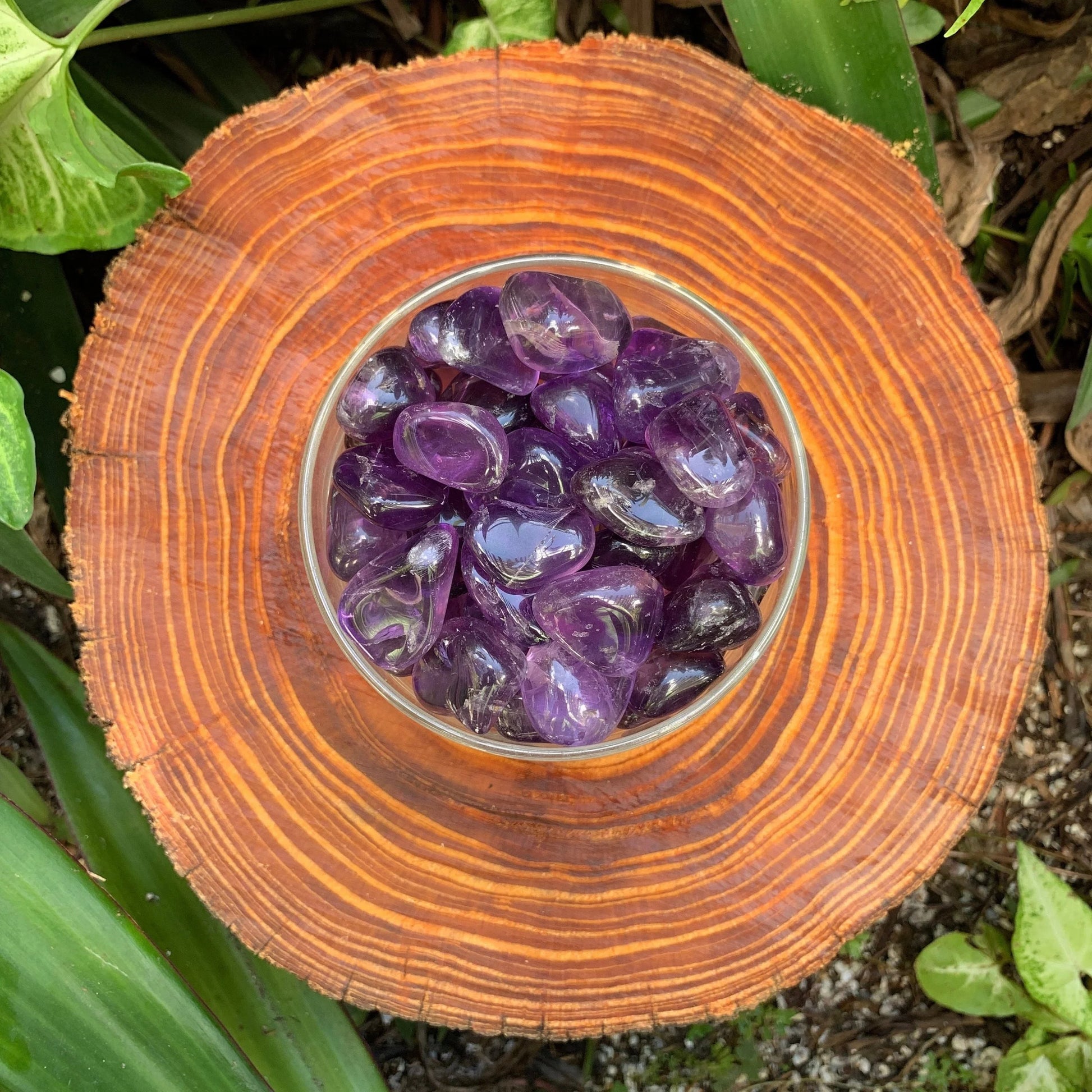 Detail shot of Grade AAA Amethyst tumbled stone under natural light
