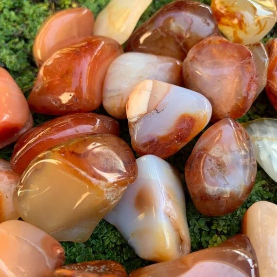 Detail shot of Grade AA Carnelian tumbled stone under natural light