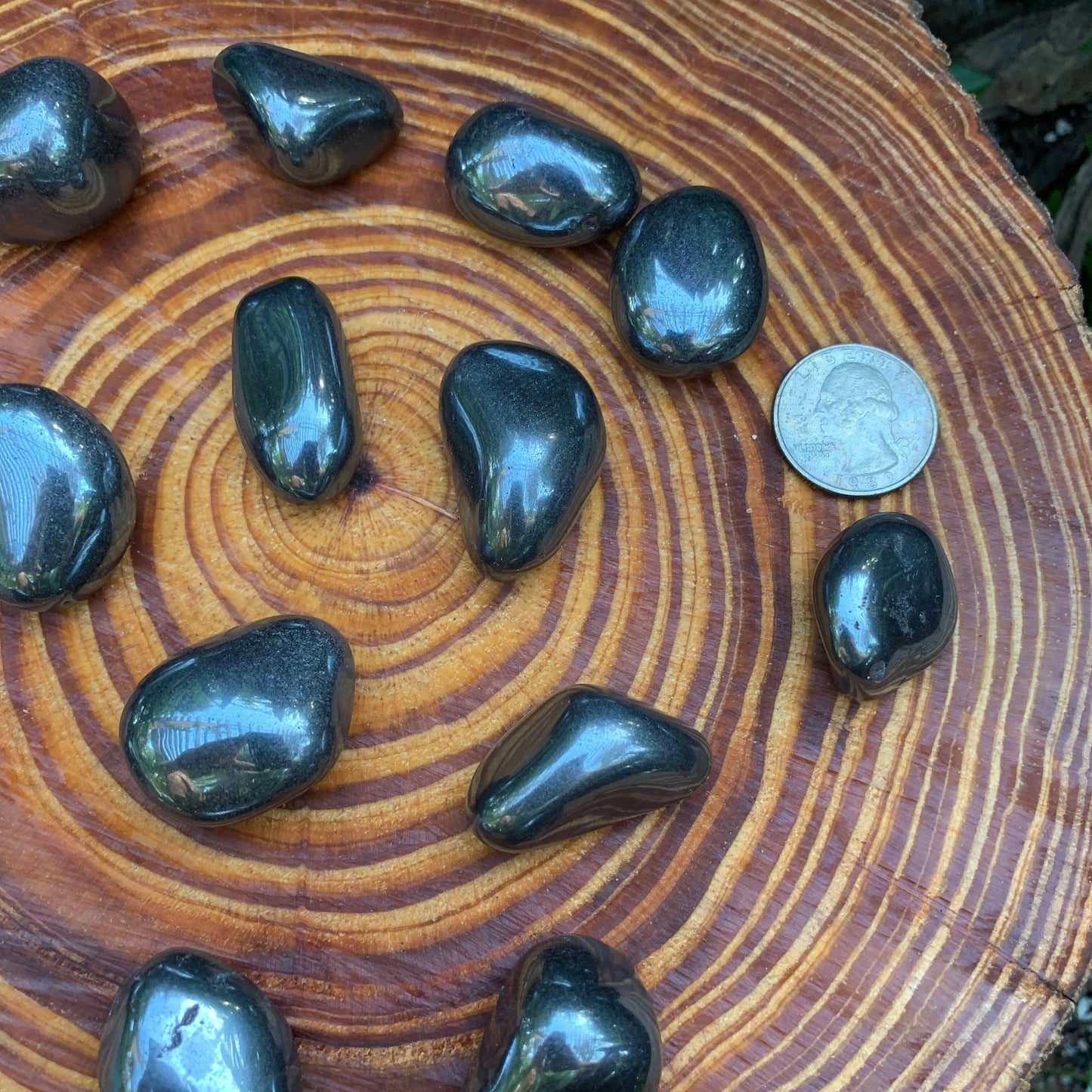 Detail shot of Grade AA Hematite tumbled stone under natural light