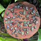 Up-close view of green Dragon Bloodstone tumbled stone, showing color depth, kept near for Confidence and Energy.