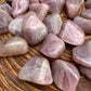 Back view of Grade AAA Blue Rose Quartz tumbled stone showing natural surface