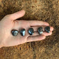 Detail shot of Grade AA Hematite tumbled stone under natural light