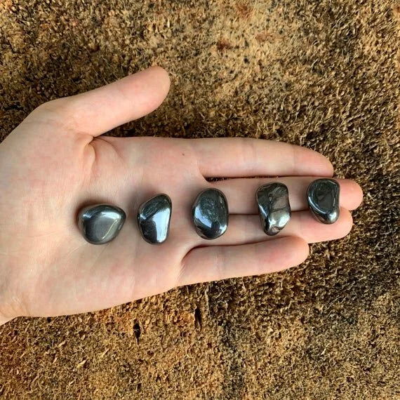 Detail shot of Grade AA Hematite tumbled stone under natural light