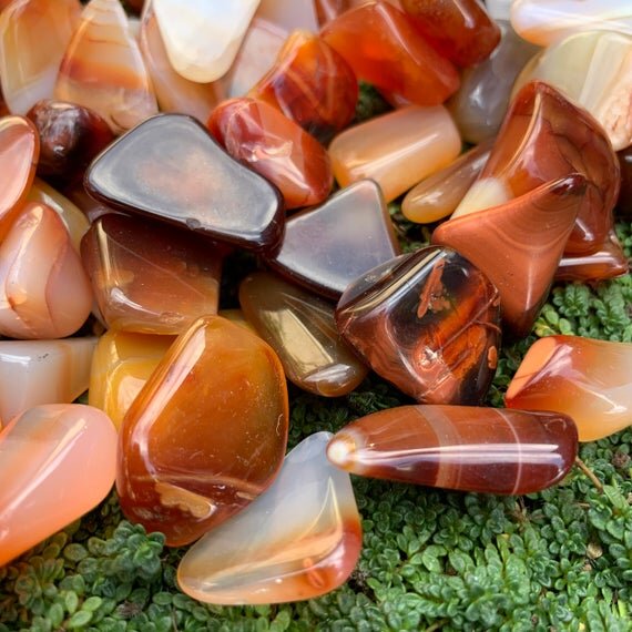 Back view of Grade AA Carnelian tumbled stone showing natural surface