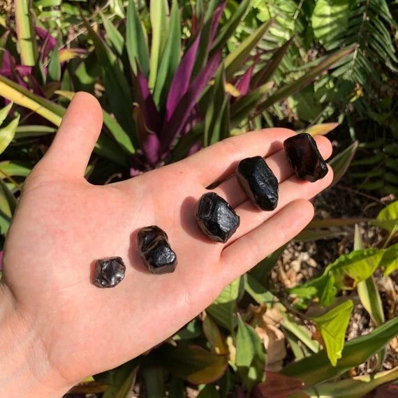 Display context of Apache Tear stone, from Arizona, United States, with hand-sized presence.