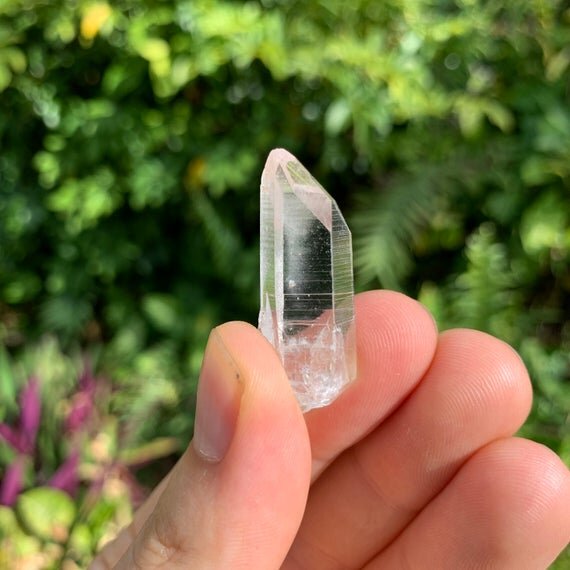 Hand-held view of a single Lemurian Quartz raw point from Colombia.