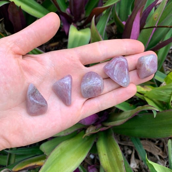 Reverse side of Grade AAA Blue Rose Quartz tumbled stone, from Madagascar, showing earthy tone.