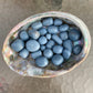 Detail shot of Grade A Angelite tumbled stone under natural light