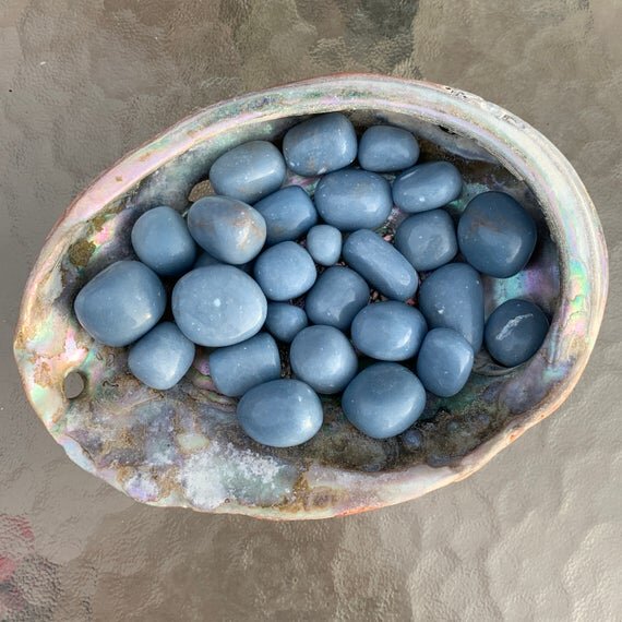 Detail shot of Grade A Angelite tumbled stone under natural light