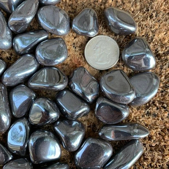 Underside view of gray Hematite tumbled stone, sourced from Minas Gerais, Brazil, carried for Grounding.