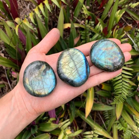 Close-up of gray Labradorite palm stone, sourced from Atsimo-Andrefana, Madagascar, showing natural variation.