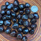 Profile view of Garnet tumbled stone, linked to Energy, Brazil-sourced.