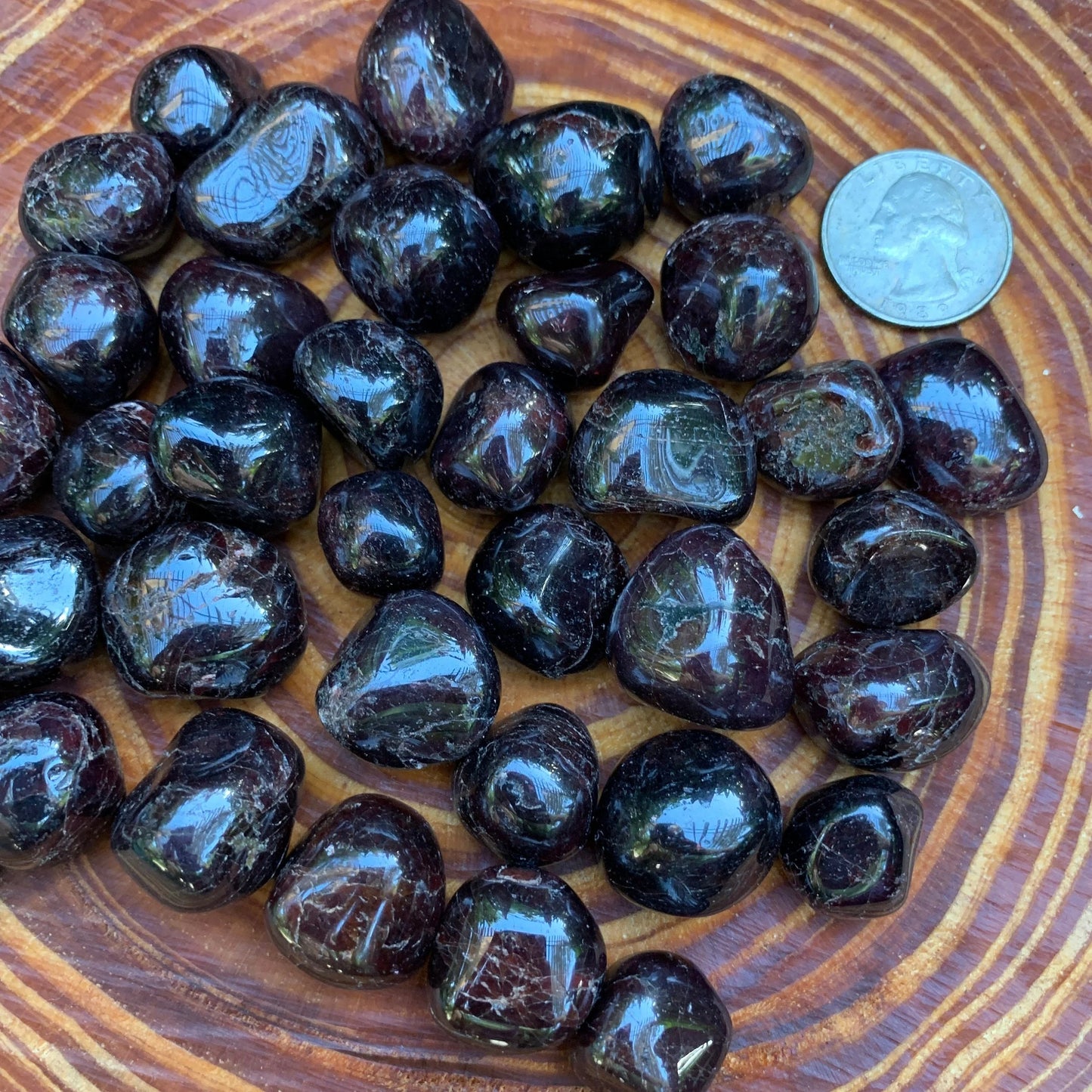 Profile view of Garnet tumbled stone, linked to Energy, Brazil-sourced.
