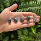 Back view of Grade AA Snowflake Obsidian tumbled stone showing natural surface
