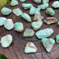 Edge-on view of Grade A Chrysoprase tumbled stone, associated with Love, showing natural inclusions.