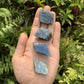 Grade aaa labradorite raw held in hand for size reference