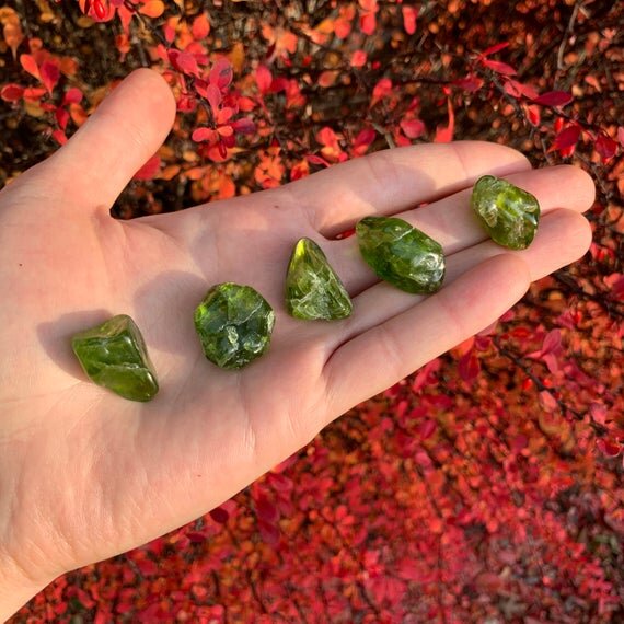Color detail of green Peridot tumbled stone, United States-sourced.