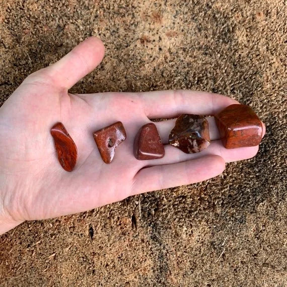 Detail shot of Grade AA Red Jasper tumbled stone under natural light