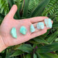 Detail shot of Grade A Chrysoprase tumbled stone under natural light