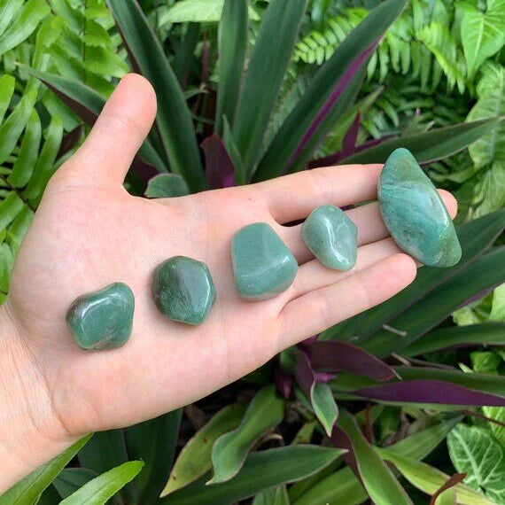 Scale comparison of Aventurine tumbled stone, from Minas Gerais, Brazil, often kept for Love, shown in a calm studio setting.
