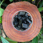 Top-side view of Black Tourmaline raw stone, showing untreated character, sourced from Madagascar.