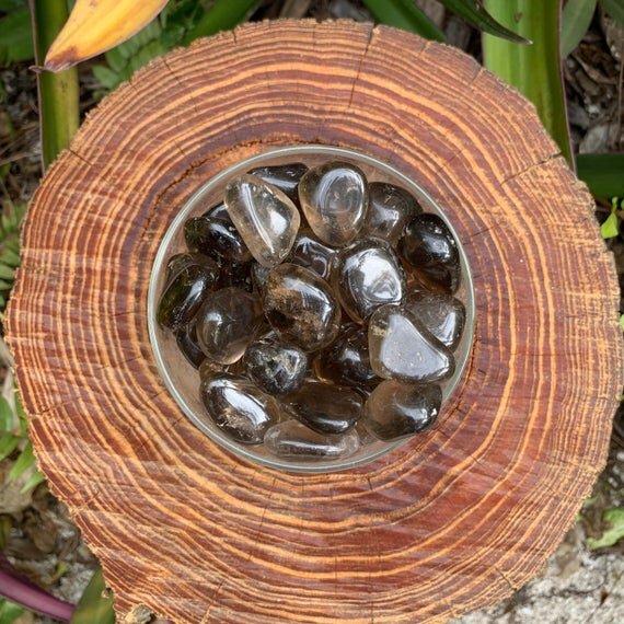 Top view of Grade AAA Smoky Quartz tumbled stone, showing natural variation, often worked with for Grounding.