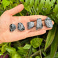 Natural light view of a Snowflake Obsidian tumbled stone, from United States.