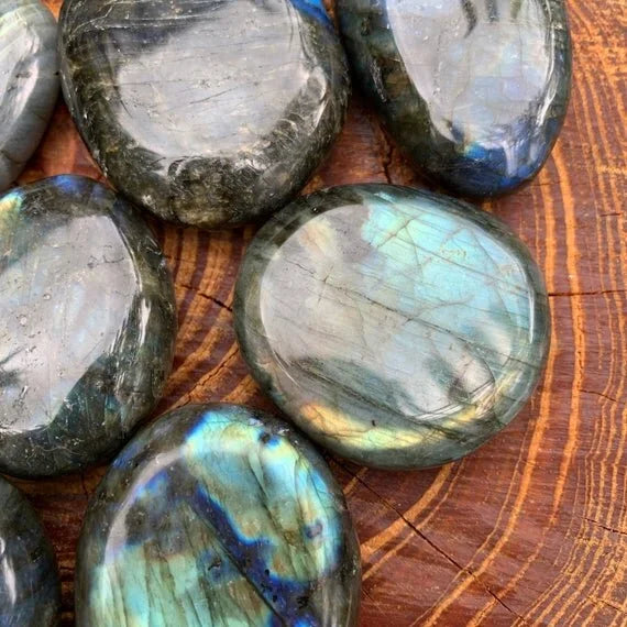 Held in palm of a Labradorite palm stone, with hand-sized presence.