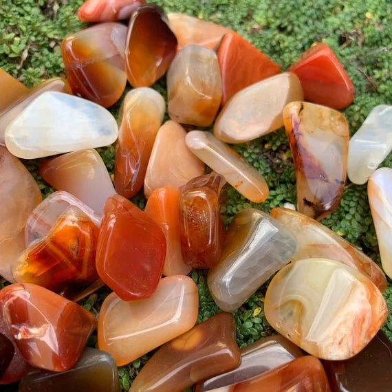 Detail shot of Grade AA Carnelian tumbled stone under natural light