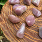 Back view of Grade AAA Blue Rose Quartz tumbled stone showing natural surface