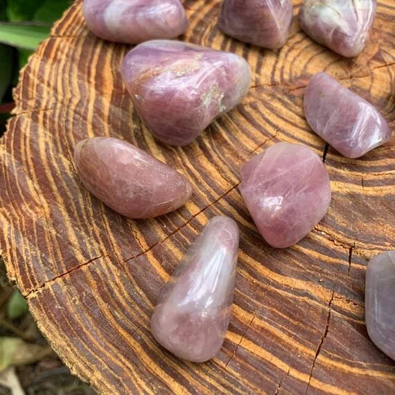 Back view of Grade AAA Blue Rose Quartz tumbled stone showing natural surface