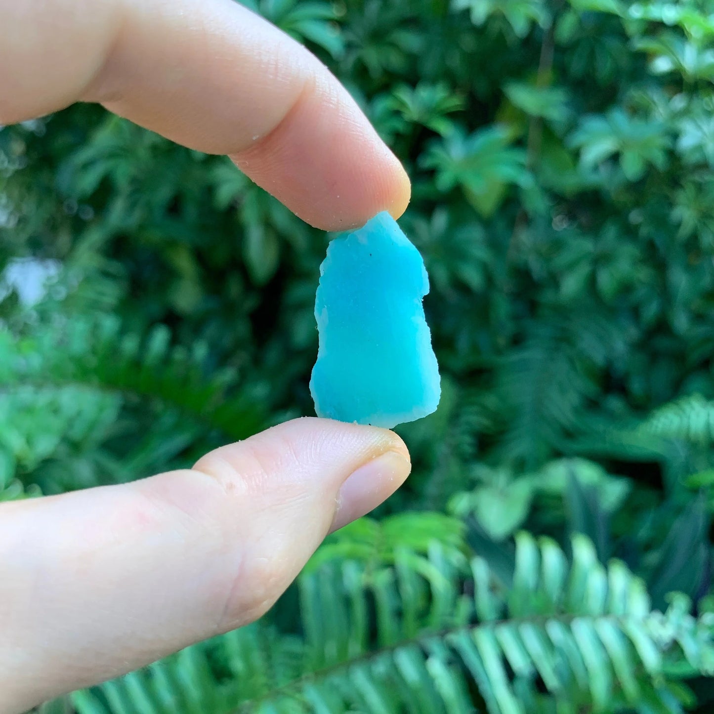Tabletop view of Amazonite raw crystal, associated with Emotional Healing, set to give a sense of weight.