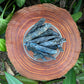 Grade aa blue kyanite raw held in hand for size reference