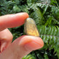 Palm-scale view of a Labradorite tumbled stone, from Madagascar.