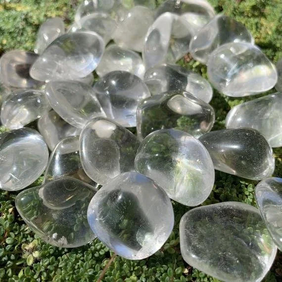 Side profile of Grade AAA Clear Quartz tumbled stone with natural form and inclusions