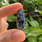 Rear view of black Snowflake Obsidian tumbled stone, kept near for Grounding and Emotional Healing.