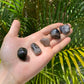 Detail shot of Grade AA Smoky Quartz tumbled stone under natural light