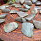 Detail shot of Grade AA Labradorite tumbled stone under natural light