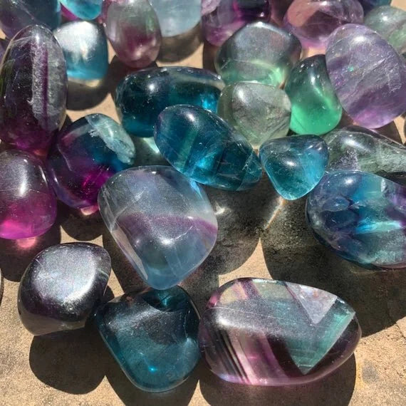 Back view of Grade AAA Fluorite tumbled stone showing natural surface