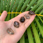 Reverse side of Smoky Quartz tumbled stone, to support Grounding and Protection, showing characteristic color.