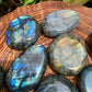 Detail shot of Grade AAA Labradorite palm stone under natural light