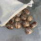 Back view of Grade AA Brown Aragonite tumbled stone showing natural surface