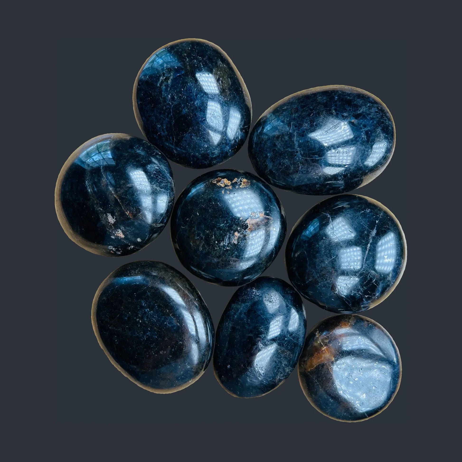 Natural surface of Iolite palm stone, showing glassy finish, Madagascar-sourced.