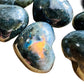 Close detail of Labradorite polished heart, kept near for Intuition, showing earthy tone.